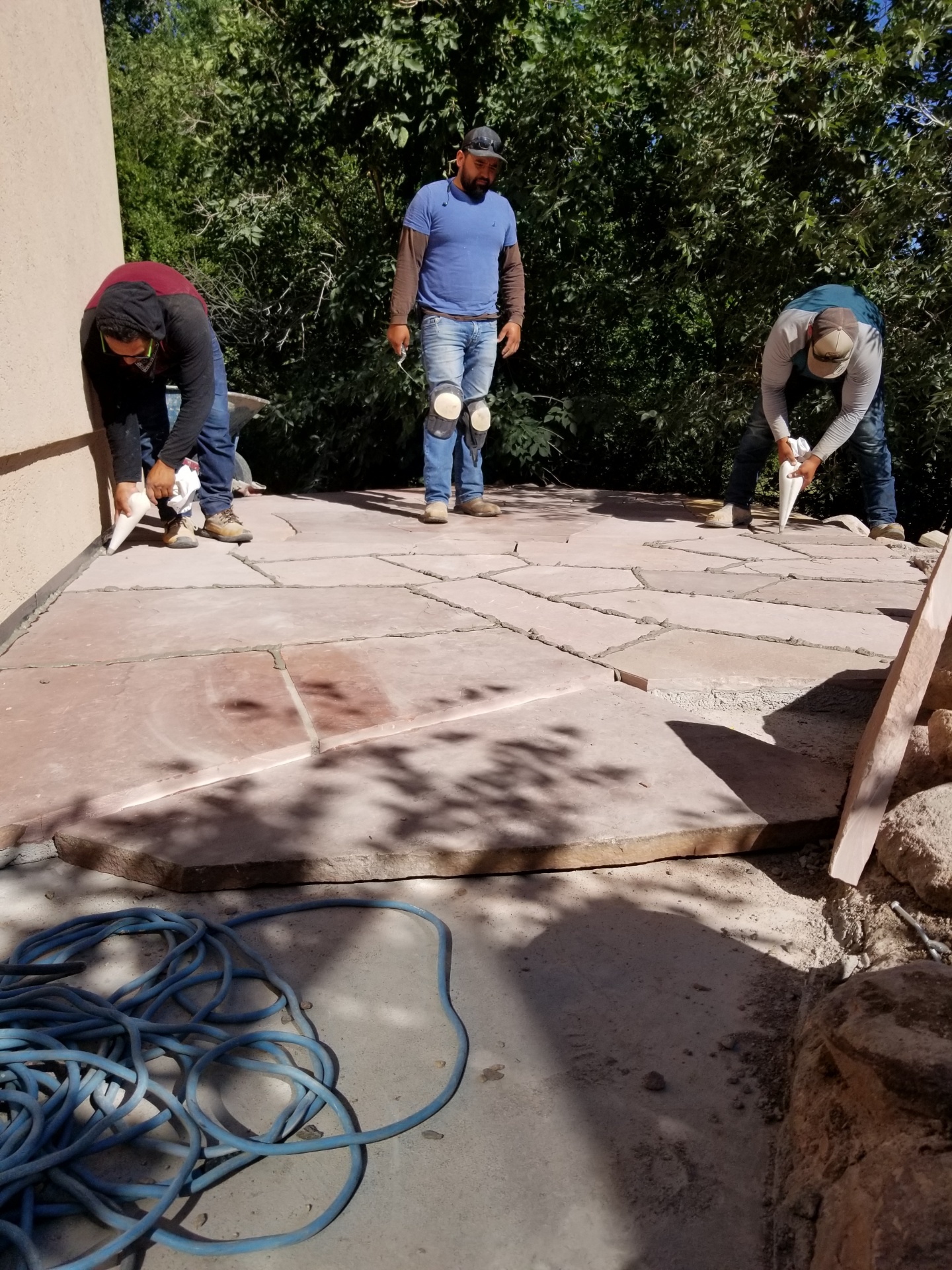 GR Sprinklers team working on a retaining wall project